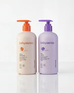 Dos botellas Babysense con dispensador tipo bomba, una de crema hidratante en tono beige y otra de baño líquido en tono morado sobre fondo blanco